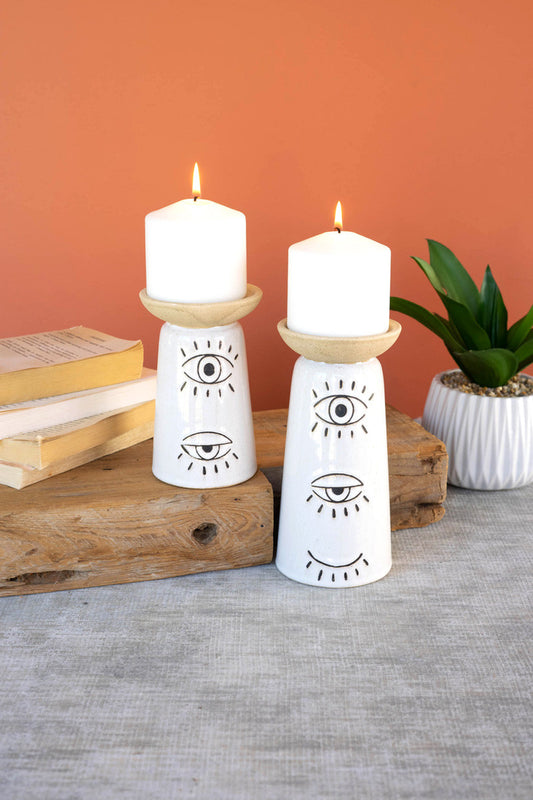 SET OF TWO CERAMIC CANDLE HOLDERS WITH EYES DETAIL