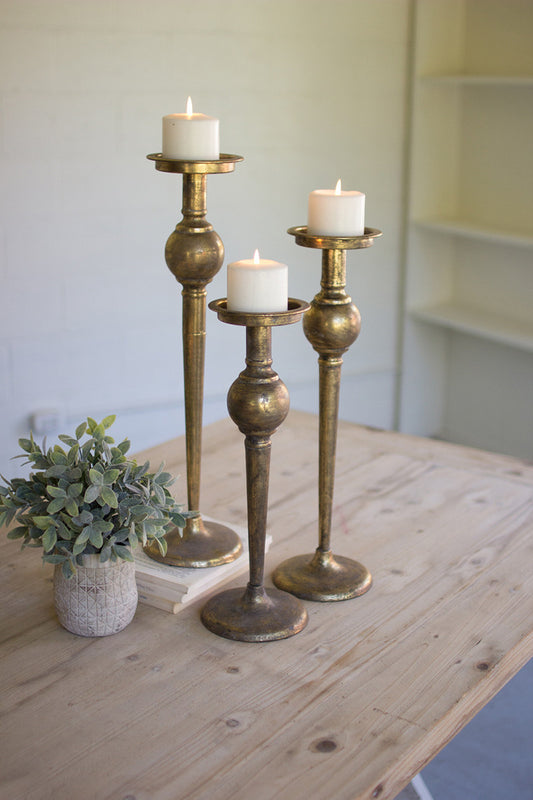 SET OF THREE ANTIQUE BRASS FINISH CANDLE STANDS
