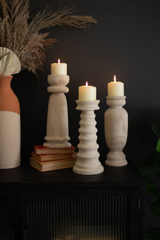 SET OF THREE TURNED WOODEN CANDLE HOLDERS