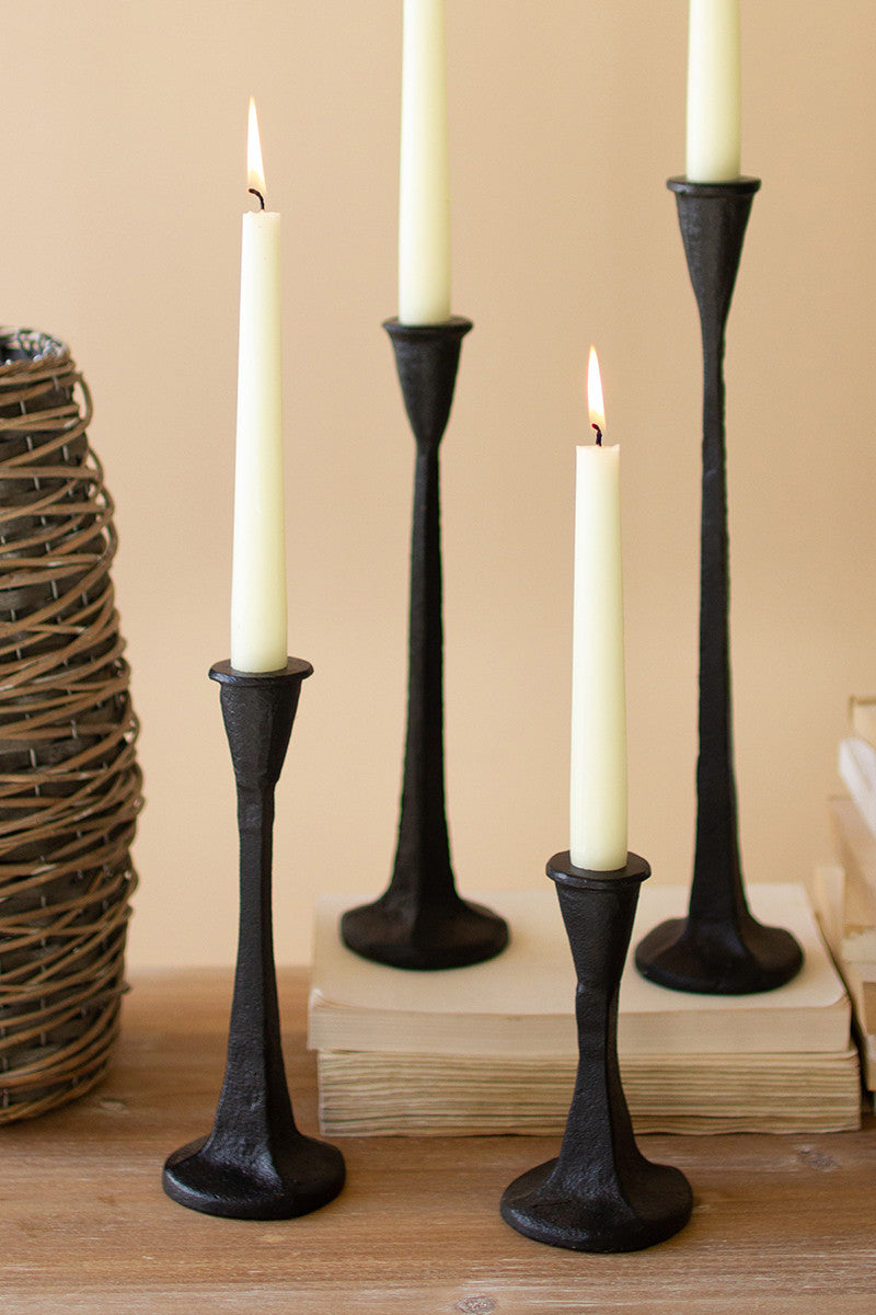 SET OF FOUR CAST IRON TAPER CANDLE HOLDERS