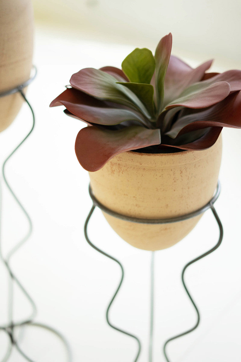 IVORY AND BLACK CLAY POT WITH WIRE SQUIGGLE BASE