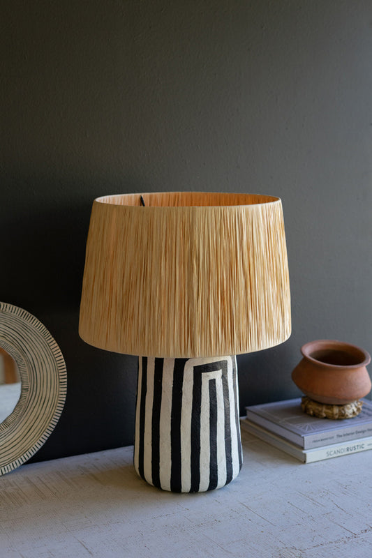 BLACK AND WHITE PAPER MACHE TABLE LAMP WITH RAFFIA SHADE