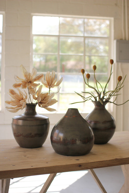 SET OF THREE RAW METAL VASES WITH COPPER DETAIL